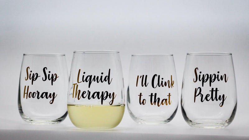 set of stemless wine glasses with metallic gold text prints 
