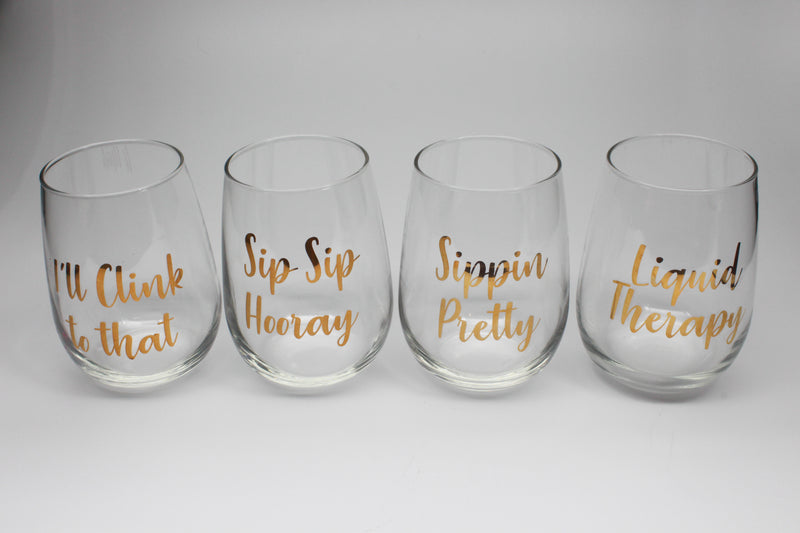 set of stemless wine glasses with metallic gold text prints 