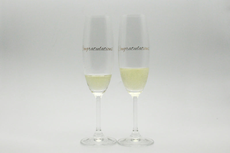 set of champagne glasses with congratulations in metallic gold text